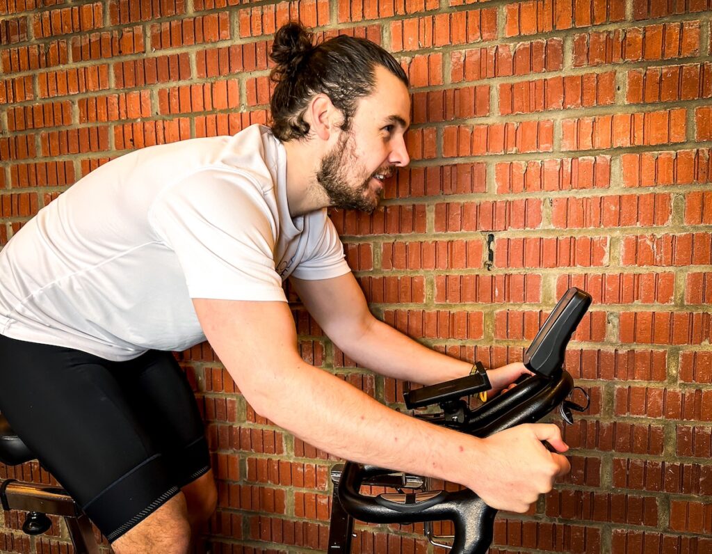 robbie ferry rides his spin bike indoors